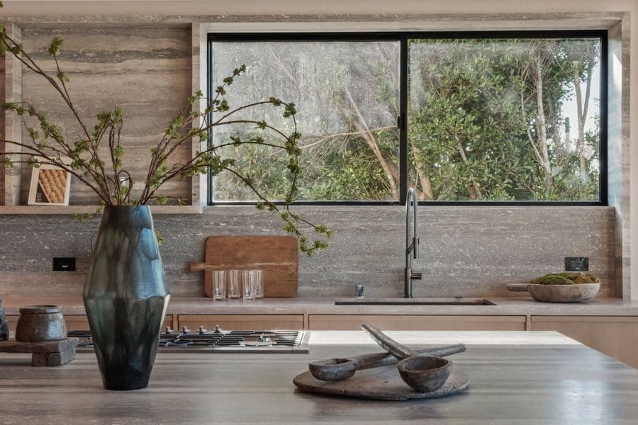 Close view of custom oak base cabinets under a Blue Ocean travertine counter and backsplash in a Malibu kitchen (Bluewater Road)